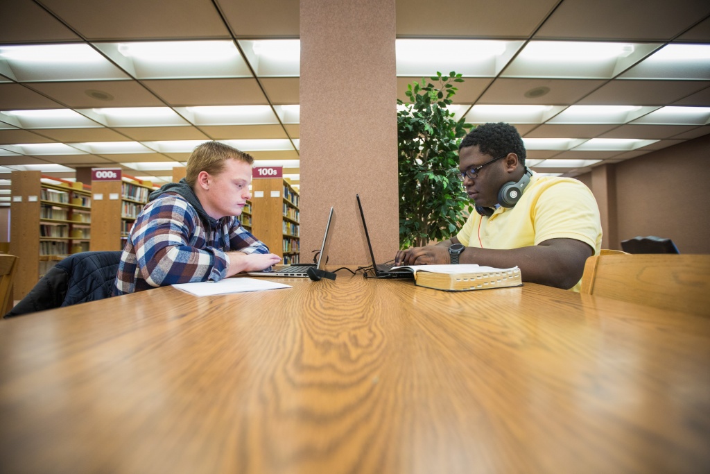 Two ministry students studying at a table in Mack Library