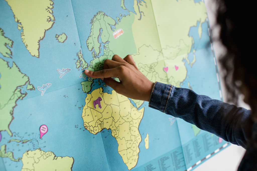 Student pointing to country on a map