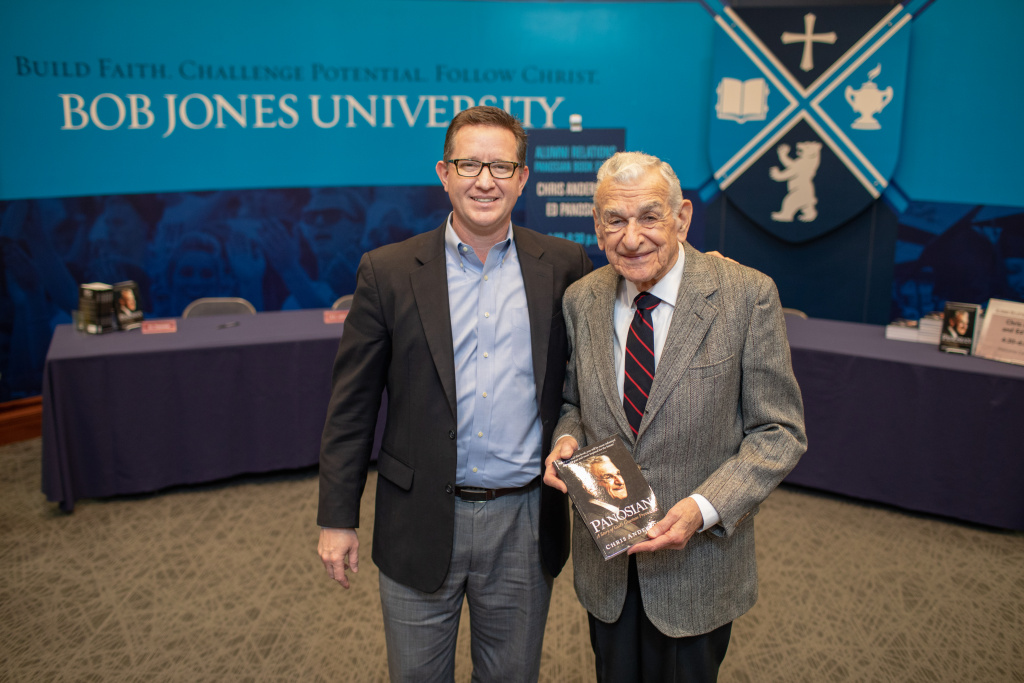 Dr. Edward Panosian with author Chris Anderson sign the recently published biography, Panosian