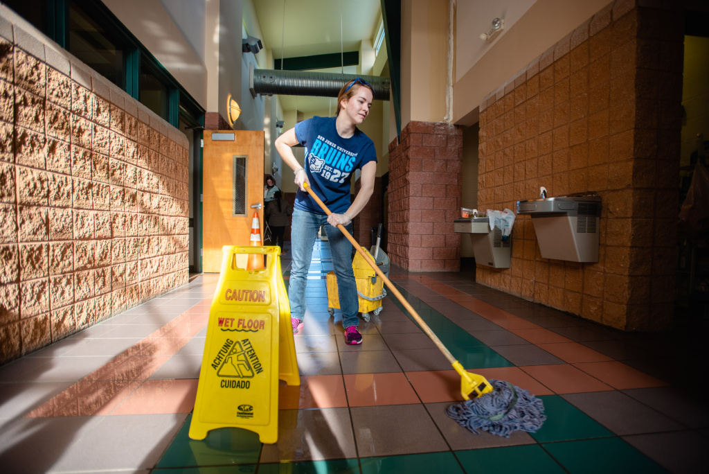 Student mopping as part of MLK Jr. Day community service outreach