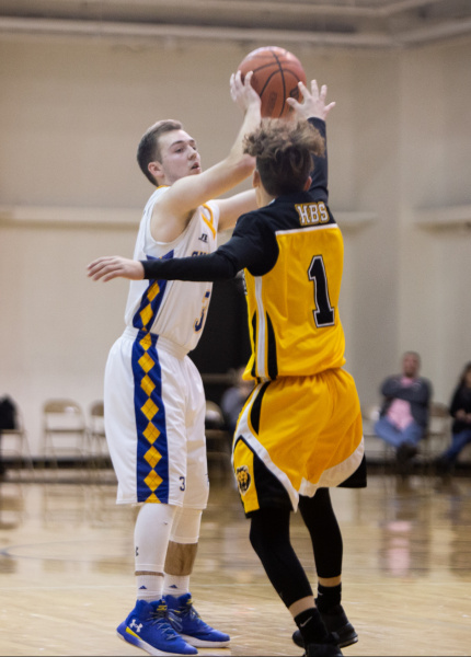 Two high school boys face off in the 47th annual invitational basketball tournament at BJU