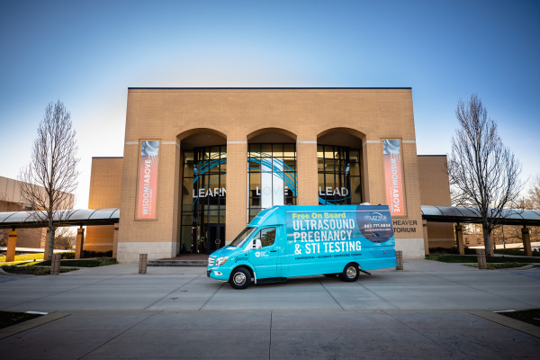 Stork van in front of Rodeheaver Auditorium
