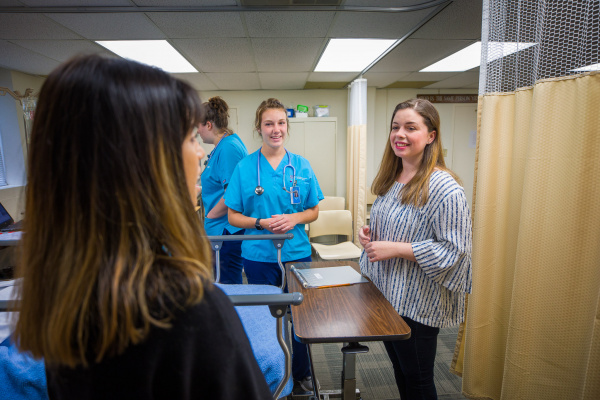 Health science students work with foreign language students in a multilingual healthcare simulation