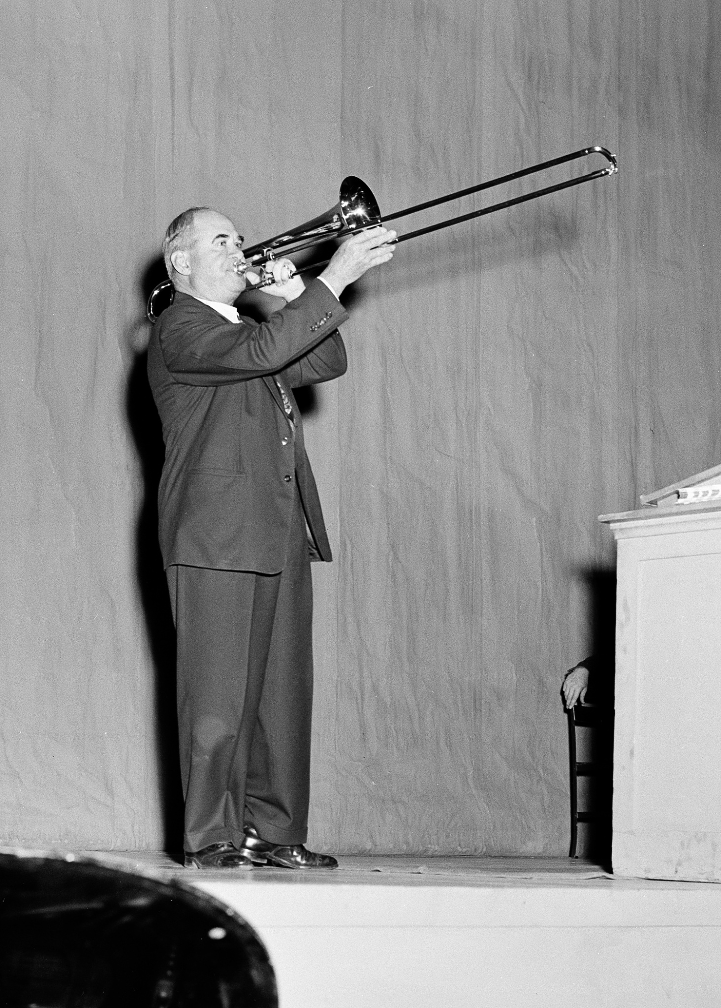Homer Rodeheaver playing the trombone on Rodeheaver stage in 1948