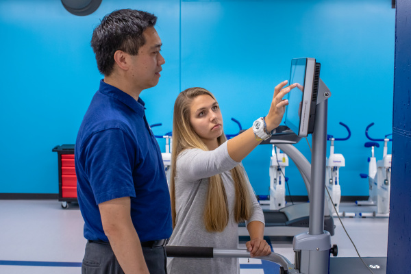Student Annelise Few practices using the Biodex Balance System with Dr. Stephen Chen