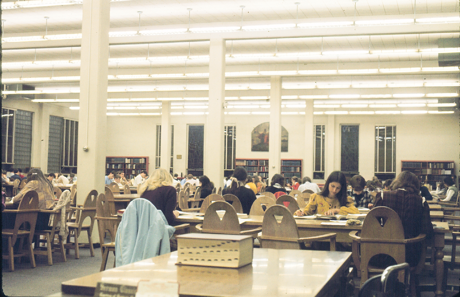 Students studying in a crowded library reading room in 1973