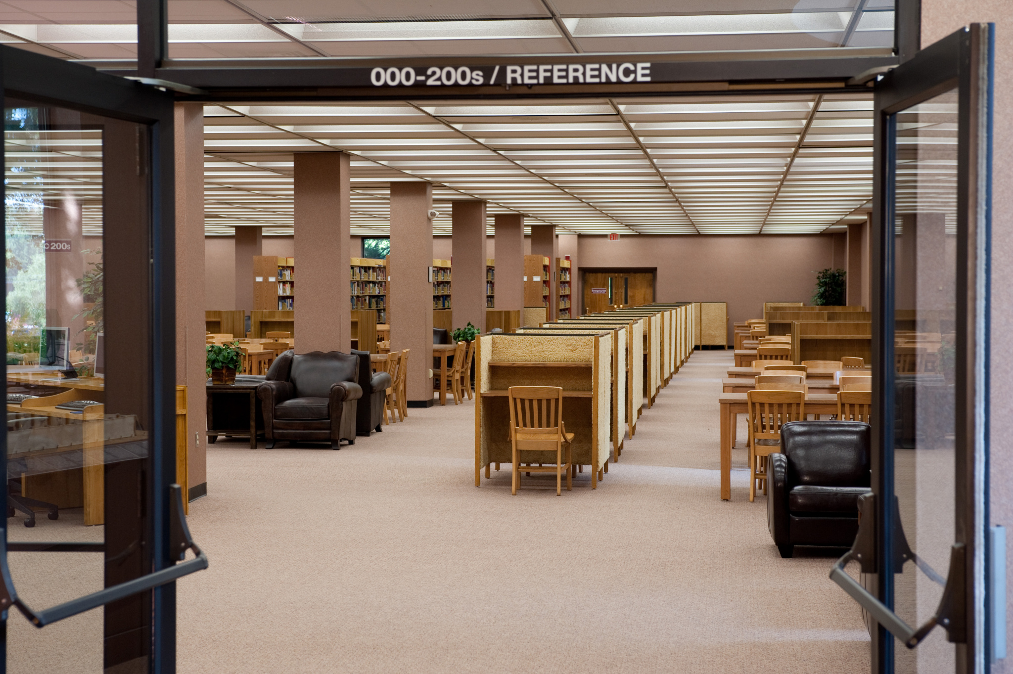 The main floor of the library with study carrels and leather chairs added in 2006