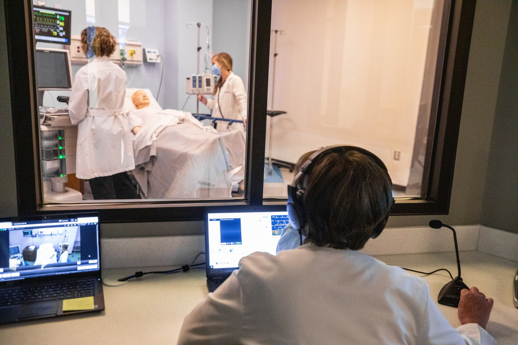 Students work in the teaching simulator lab in the School of Health Professions facility