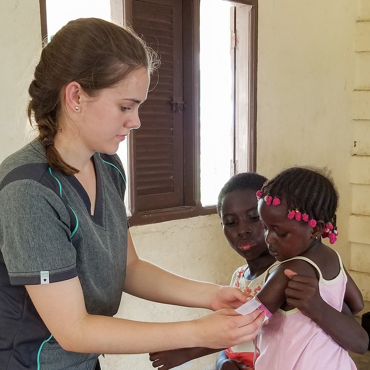 A nurse at Hope Christian Hospital applies a bandaid to the arm of a child (Submitted Photo)
