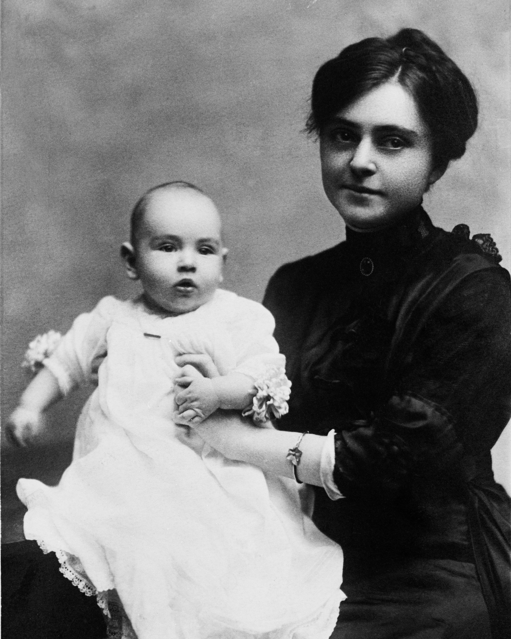 Photo of of Mary Gaston holding Bob Jones Jr. as a baby on her lap for a formal portrait. 1913