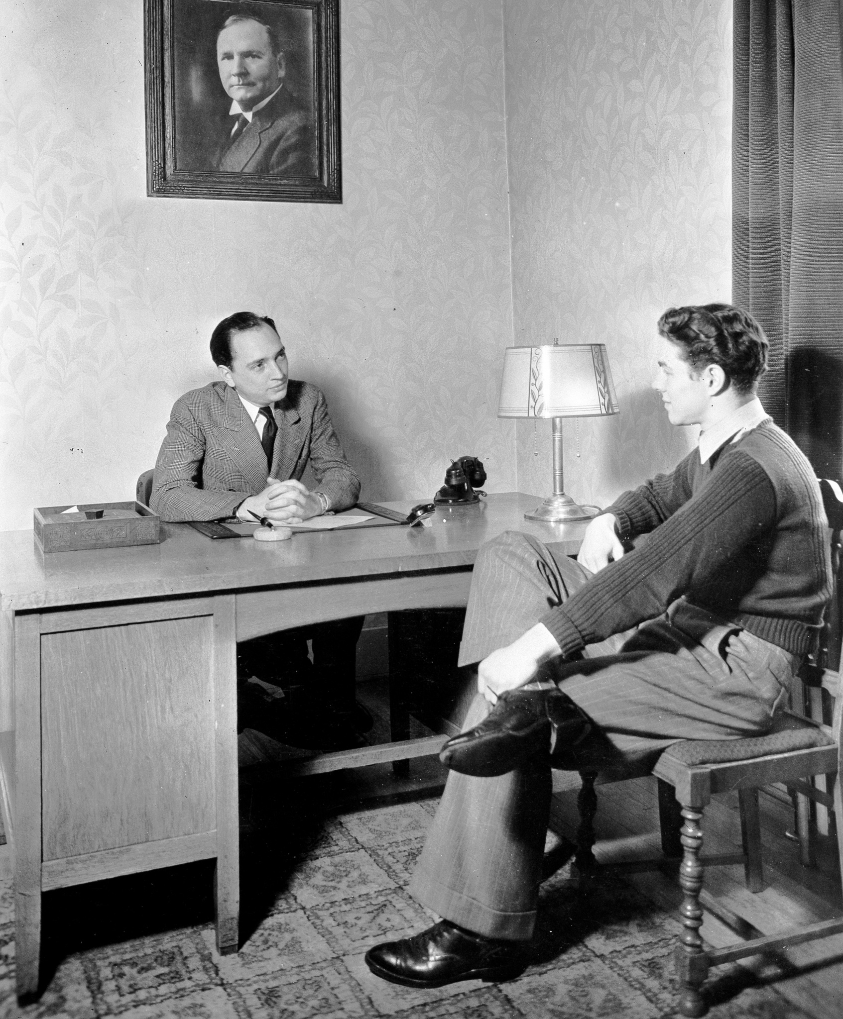 Photo of Bob Jones Jr. in his office with a student, 1935