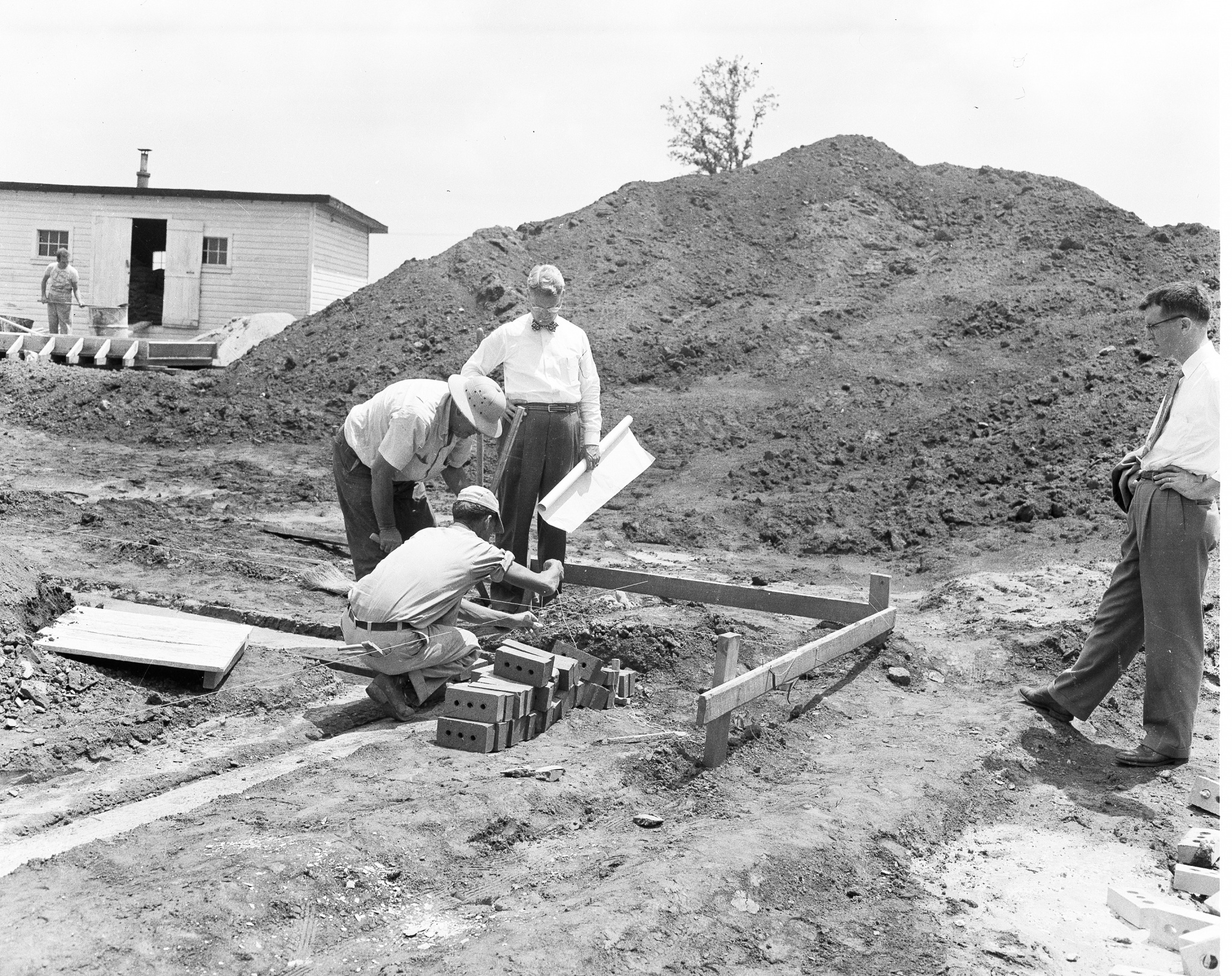 Photo of R K Johnson at the girl's dorm construction site 1951-52