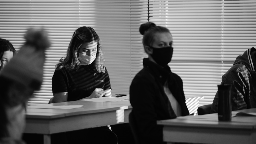 Black and white photo of students wearing masks in class during COVID-19 pandemic