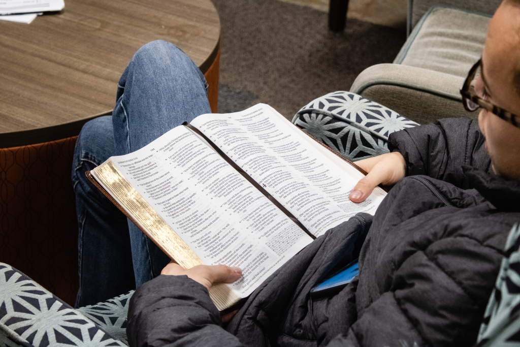 Student reading Bible