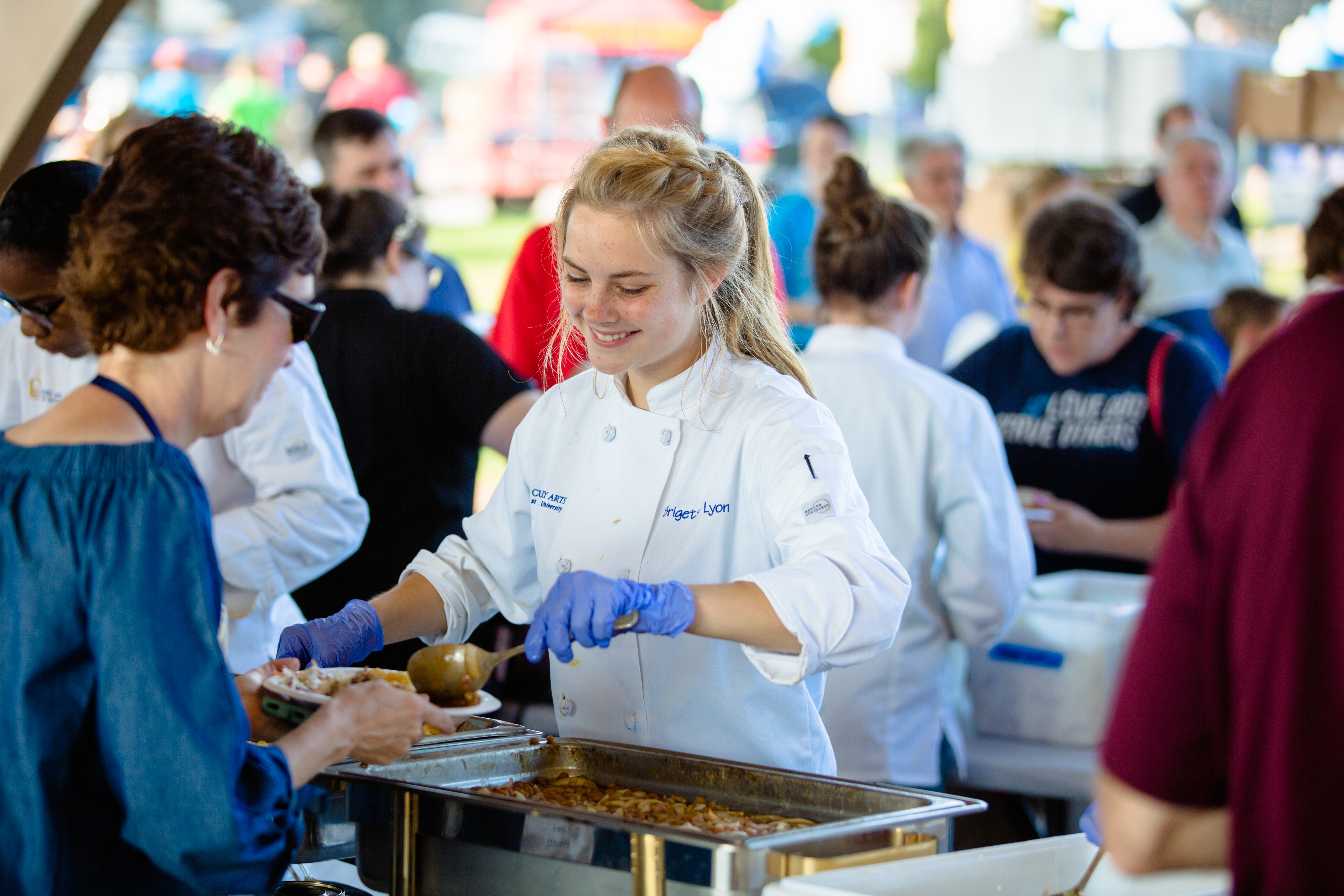 Students in the culinary arts program cater and serve the BBQ Bash during Homecoming