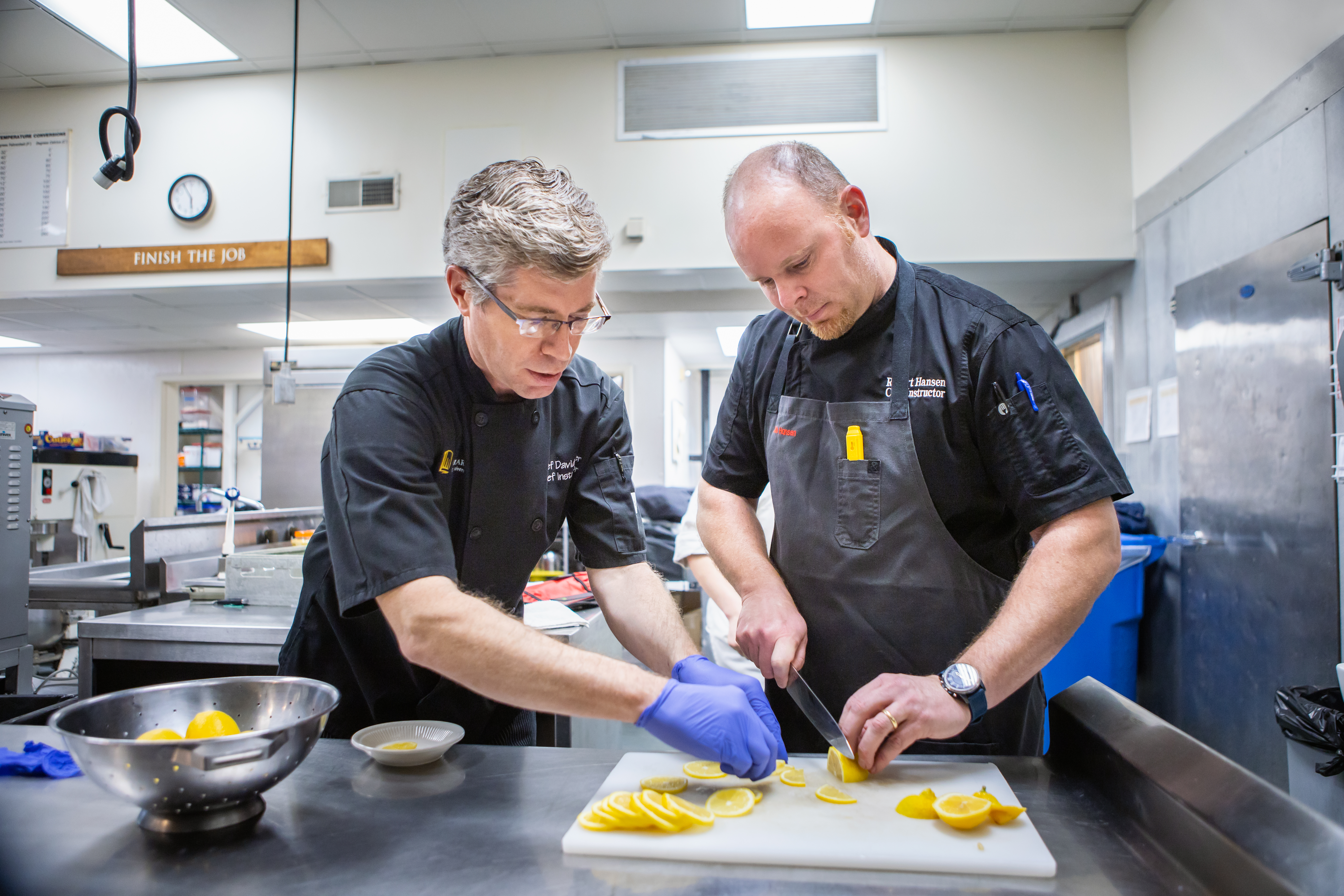 David Miller and Rob Hansen prepare food for a fine dining series