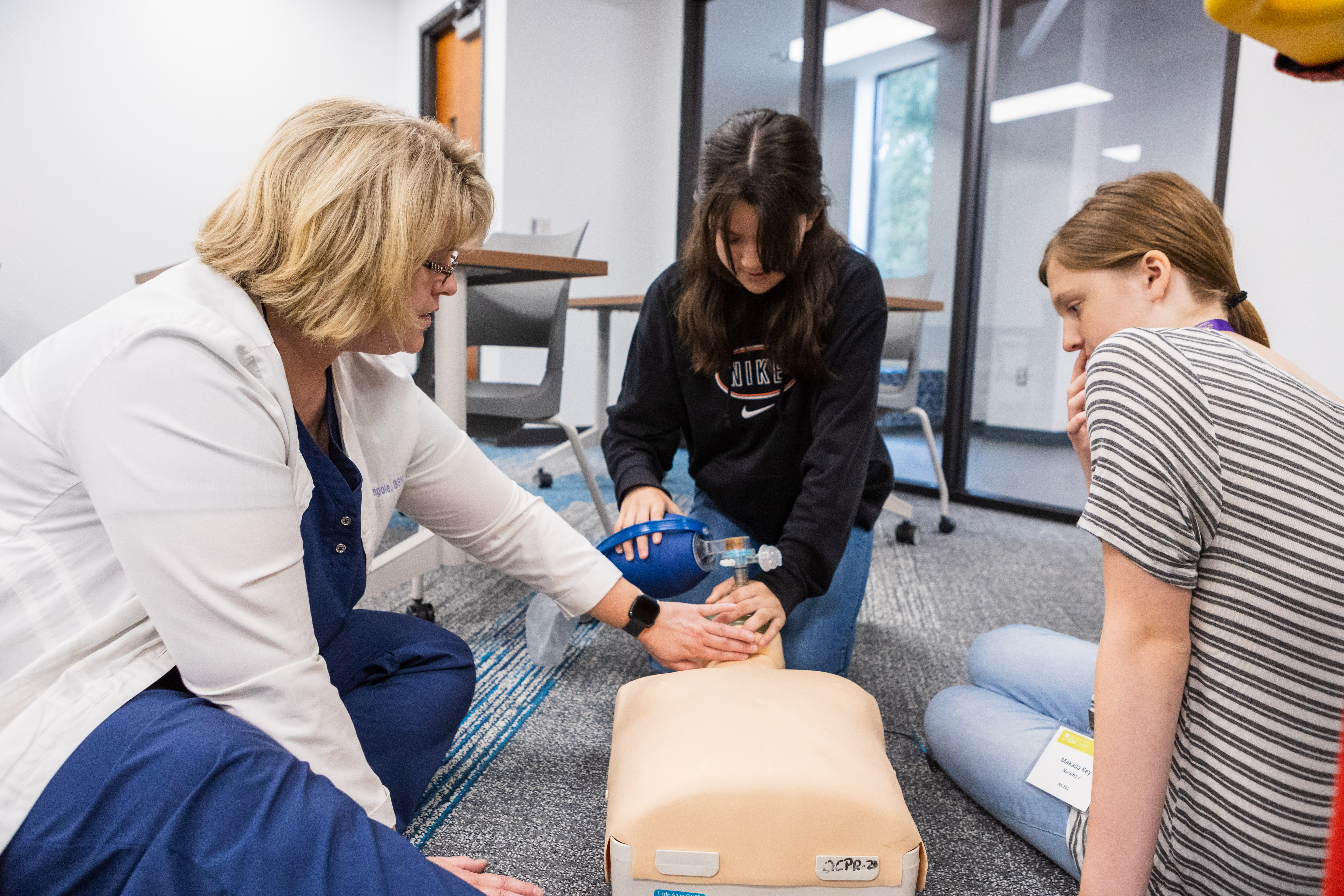Campers attending the nursing EDUcamp learn CPR from Division of Nursing faculty Dr. Kathryn Wampole