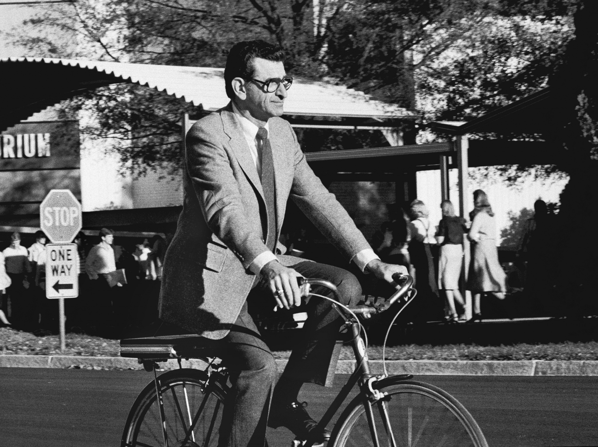 Dr. Ed Panosian riding his bicycle on campus