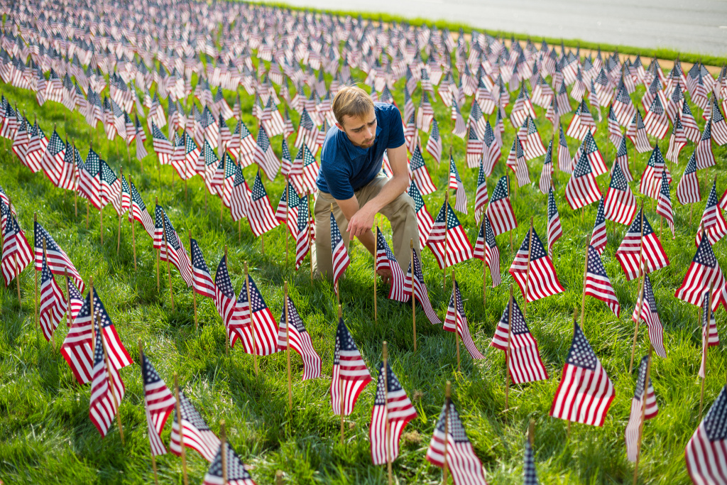 A BJU student places flags in the 9/11 tribute for the 20th anniversary